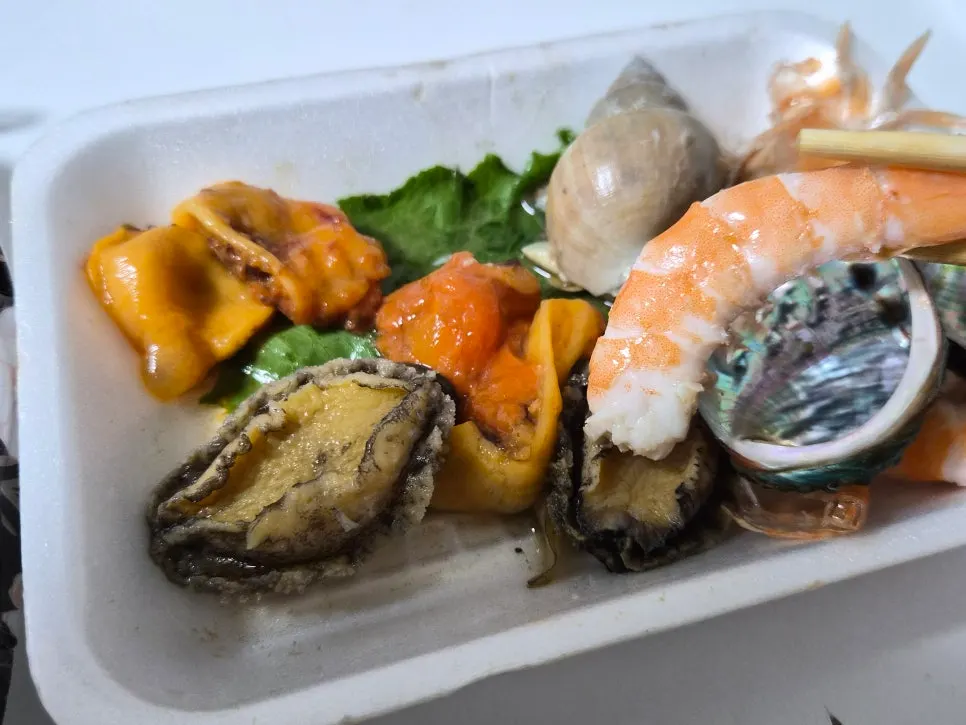 Generously packed mixed sashimi with seafood side dishes
