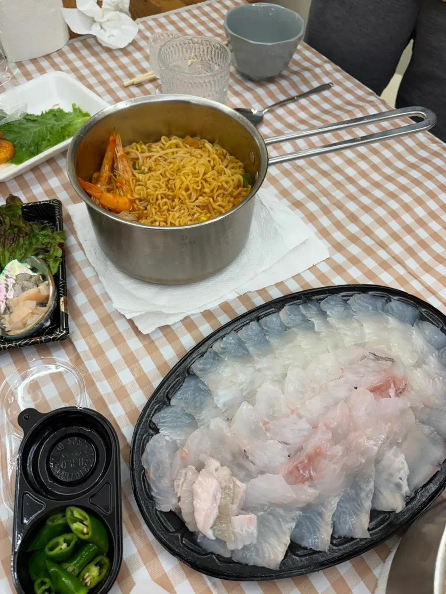 Halibut and rockfish sashimi packed together with wrapping greens