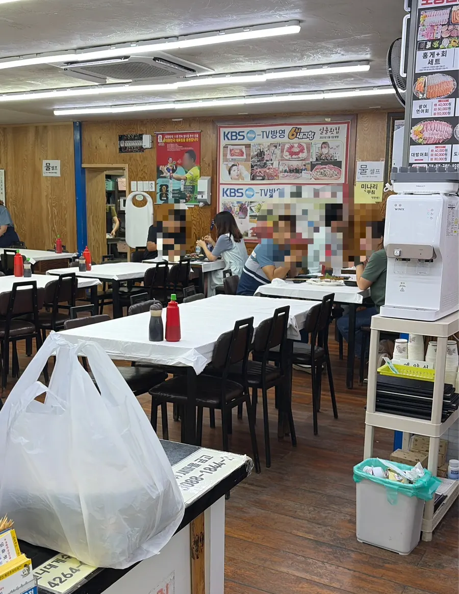 Spacious interior of Ilchul Hoetjip with TV appearance certificates on the wall