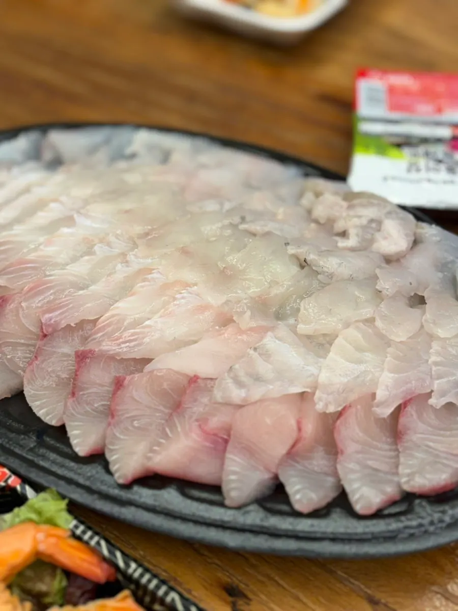 Thick layers of stacked live-fish sashimi