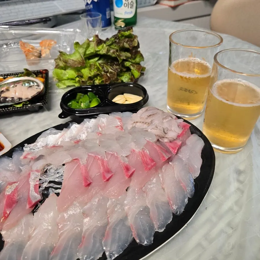 Assorted sashimi arranged on a large plate