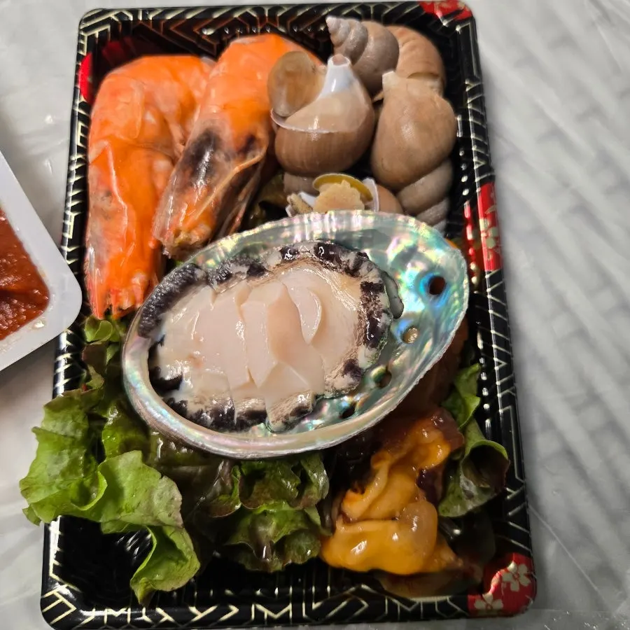 Shrimp and abalone served alongside the sashimi