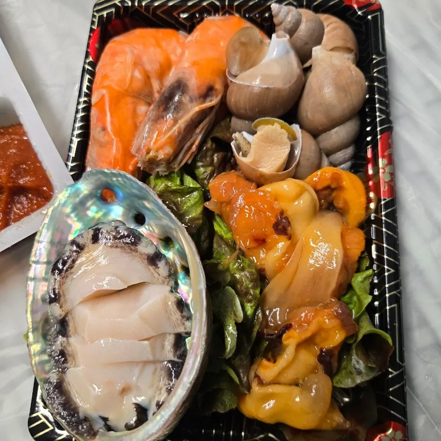 Eating shrimp and abalone alongside the sashimi