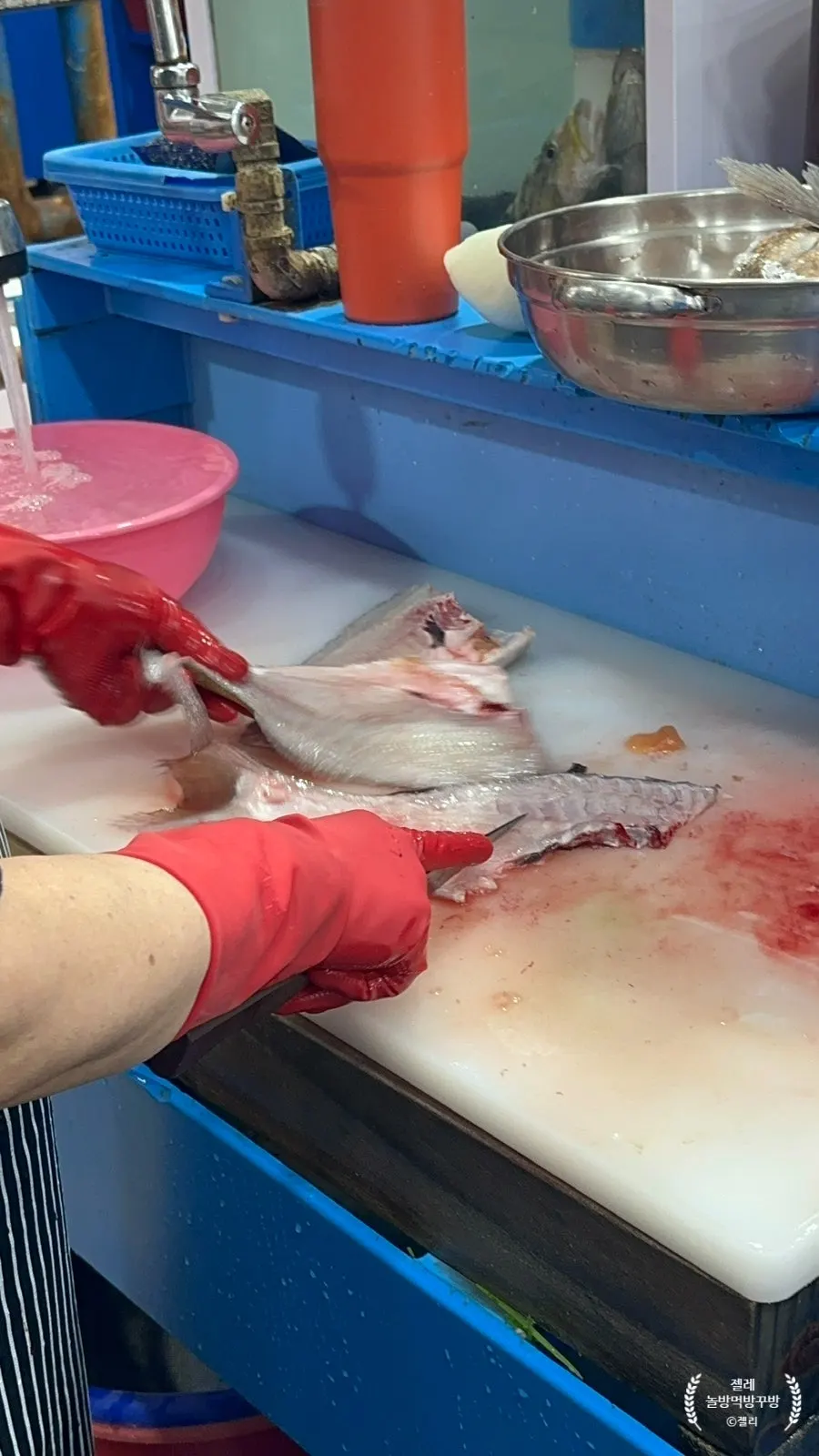 Fish being prepped and sliced into sashimi right in front of customers