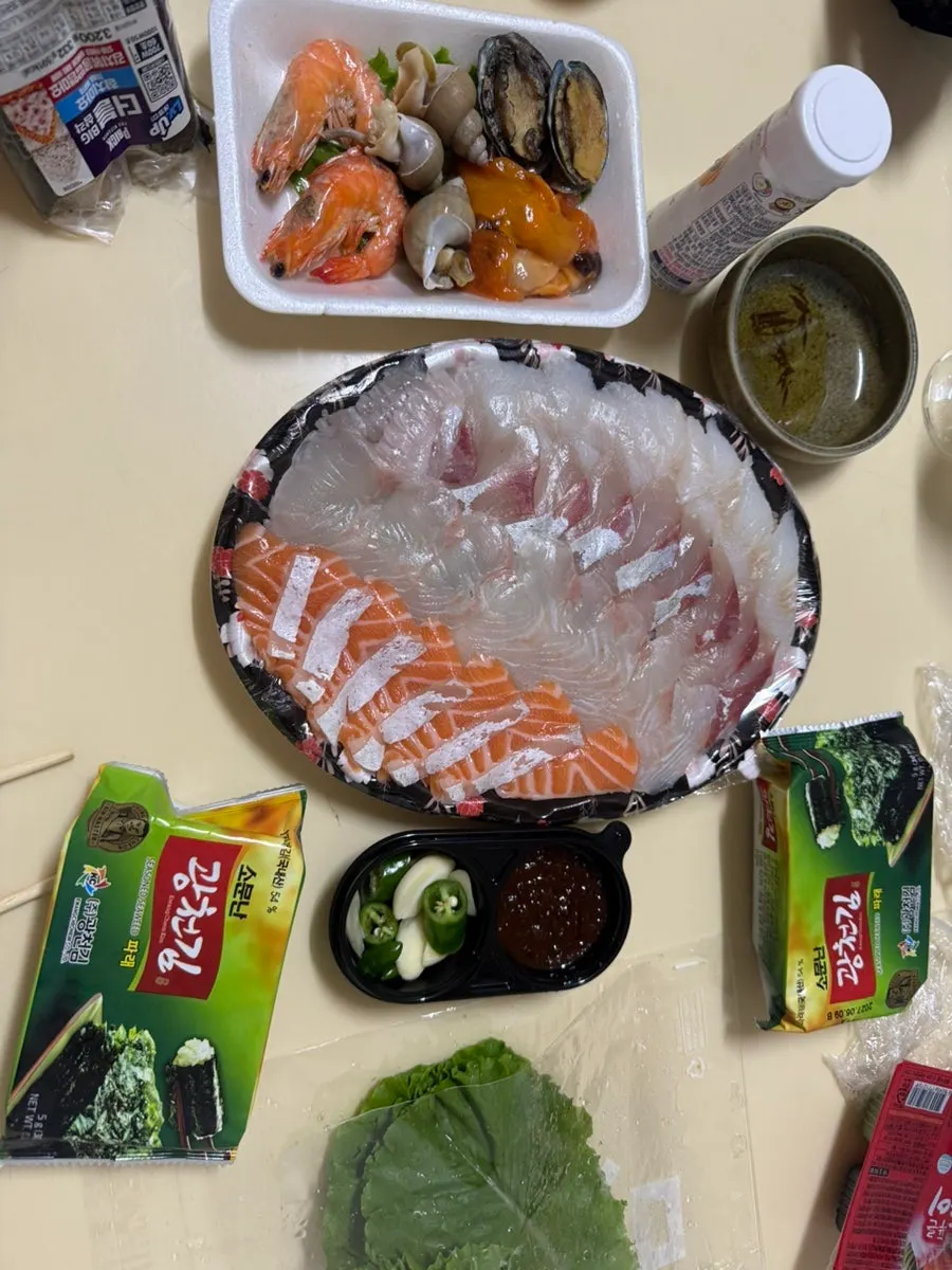 Sashimi and side dishes spread out for dinner at the accommodation