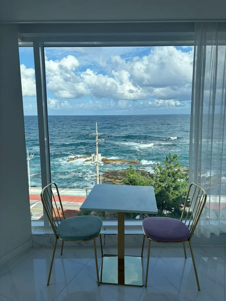 Juncheon sea beyond the room's floor-to-ceiling window