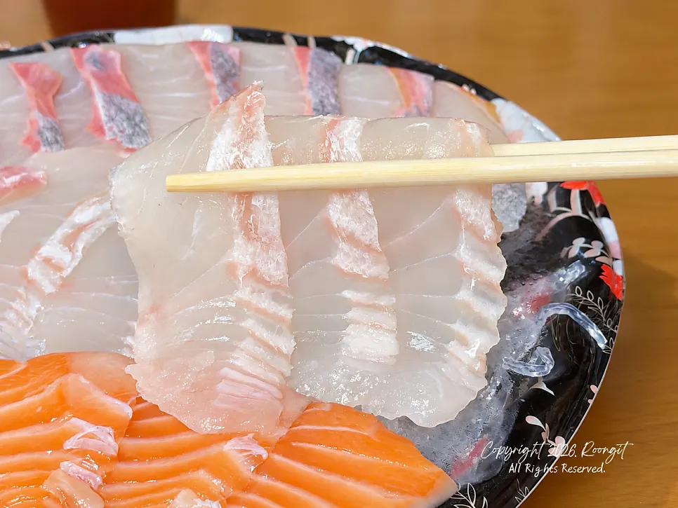 A thick-cut piece of sashimi