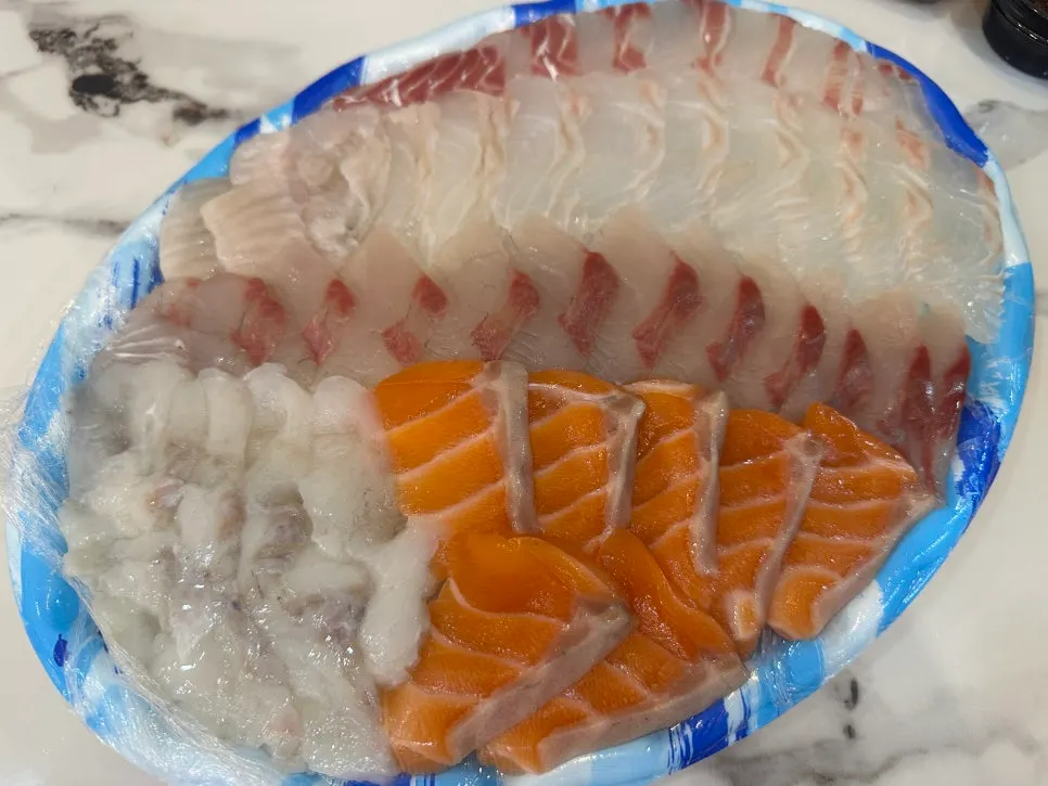 Takeout box with abalone, sea squirt, conch, and shrimp