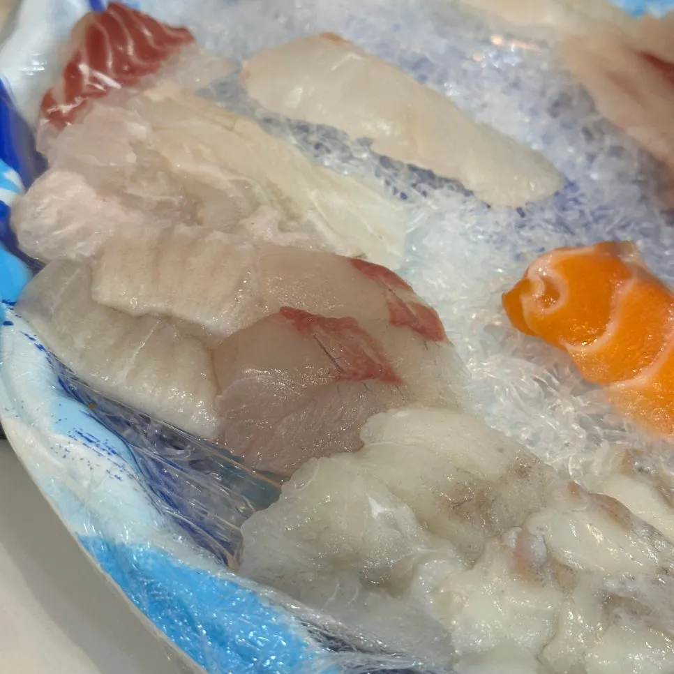 Plate of mixed sashimi with salmon, sea bream, and flounder