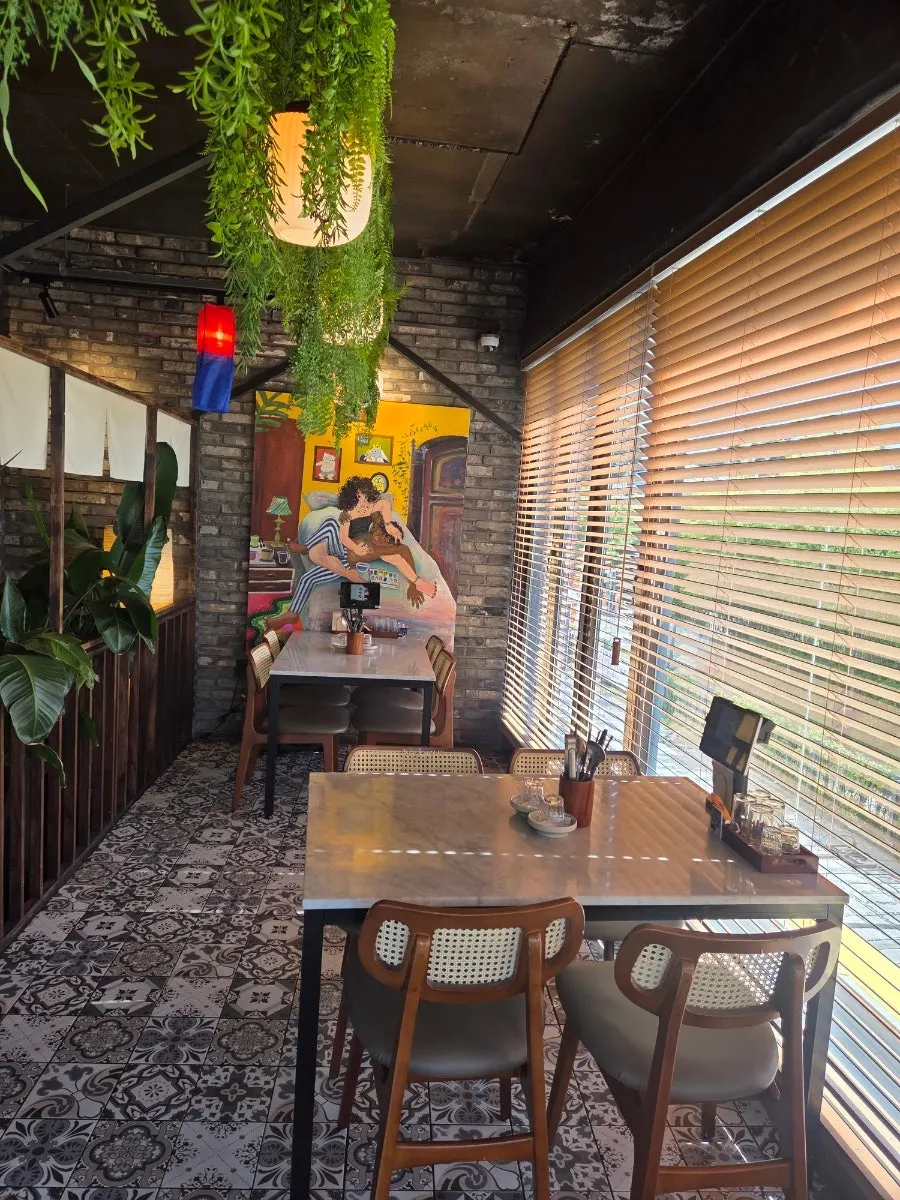 Window-side seating at Ju Myeongdang with an outdoor view through the full window