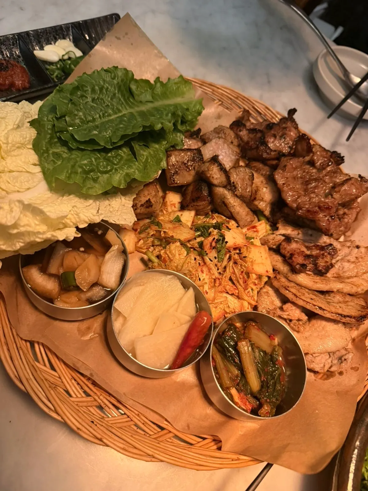 A plate of pre-cooked meat with a smoky char