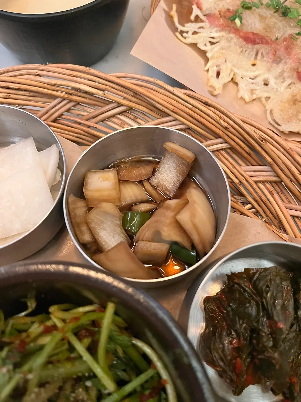 Handmade side dishes including pickled onions, radish pickles, and mustard leaf kimchi
