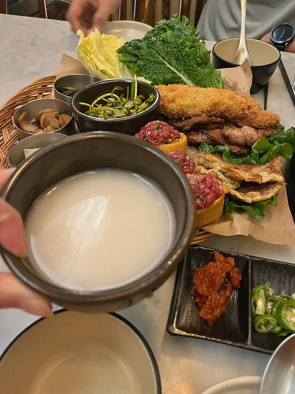 Korean drinking table spread with makgeolli