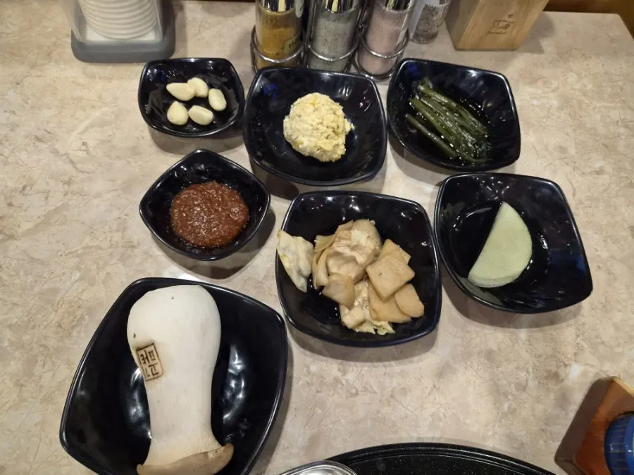 Side dishes and sauces set out after ordering