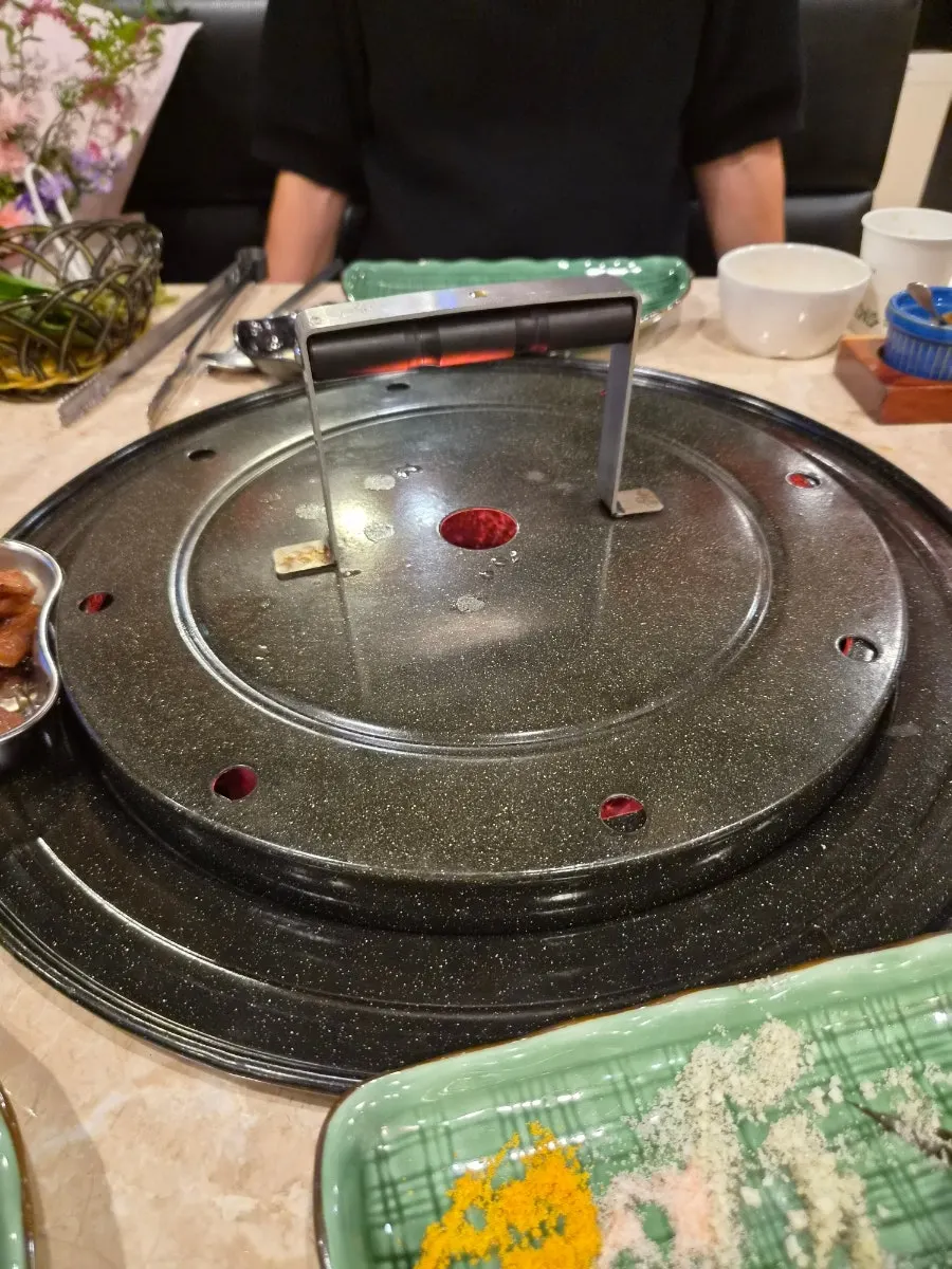 Charcoal grill with lid closed to boost the heat