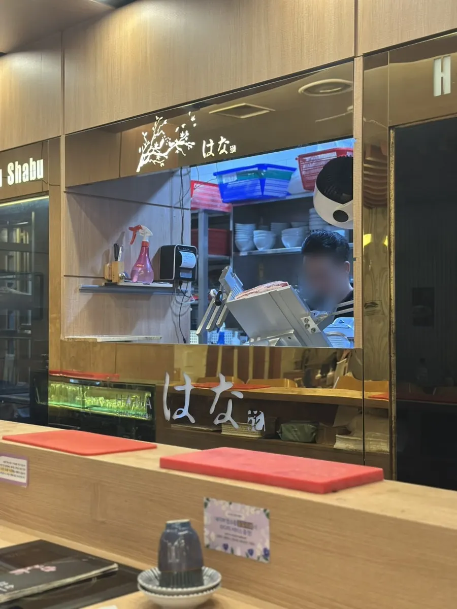 Reading a book at the counter seat while waiting for a friend