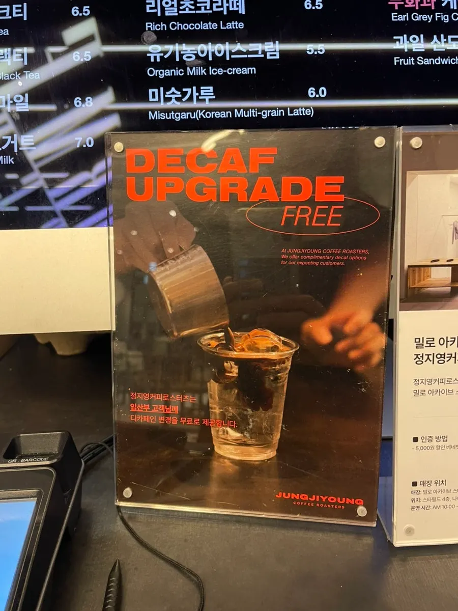 Sign explaining decaf and oat milk option changes
