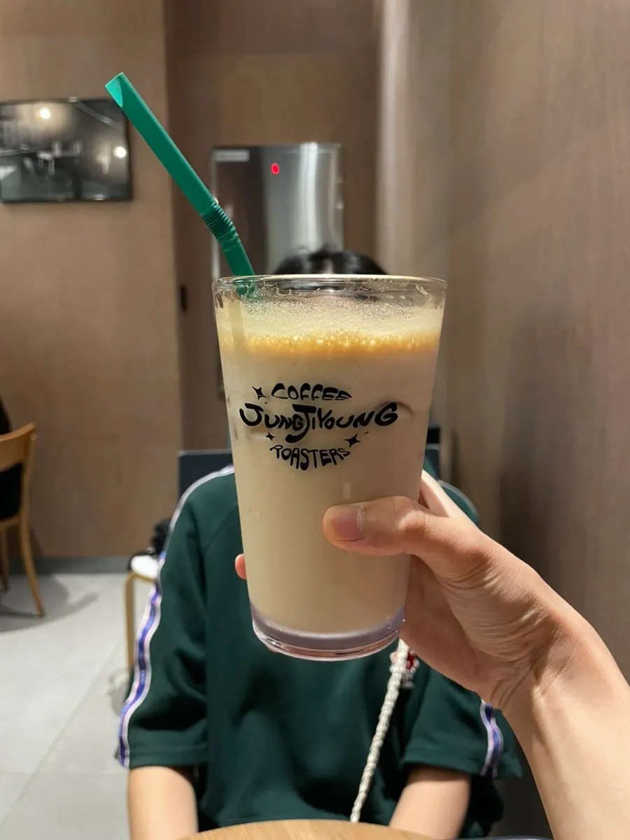 Coconut latte with a straw inserted