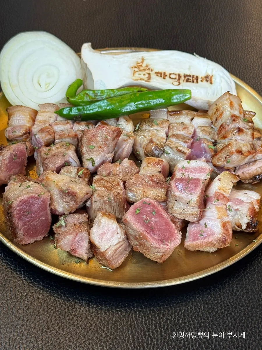 A spoonful of white rice topped with bracken and kimchi