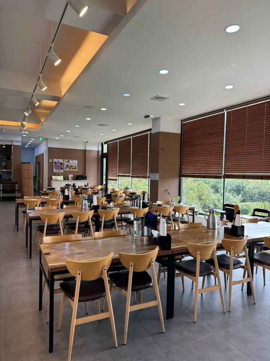 Interior dining hall of Jungmun Godeungeo Ssam-bap with long tables