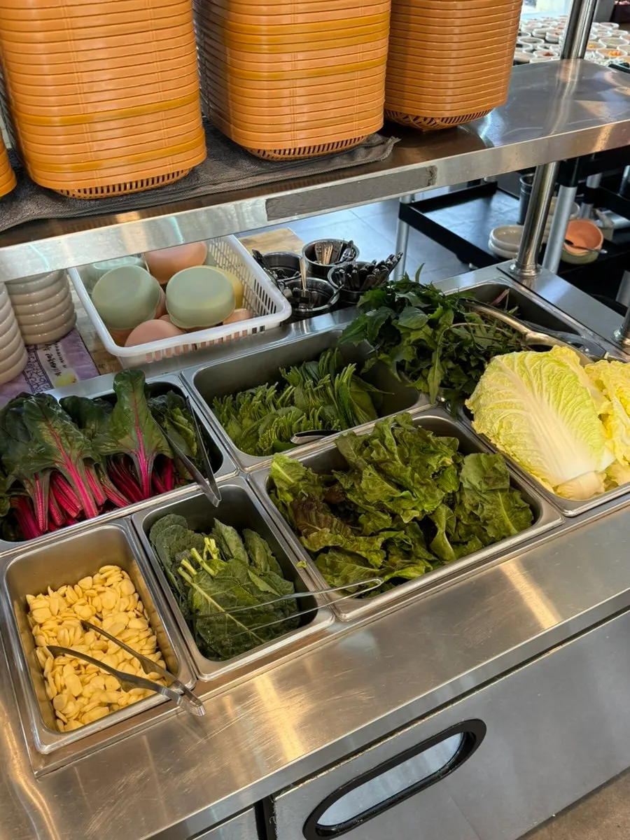 Assorted side dish station next to the lettuce wraps