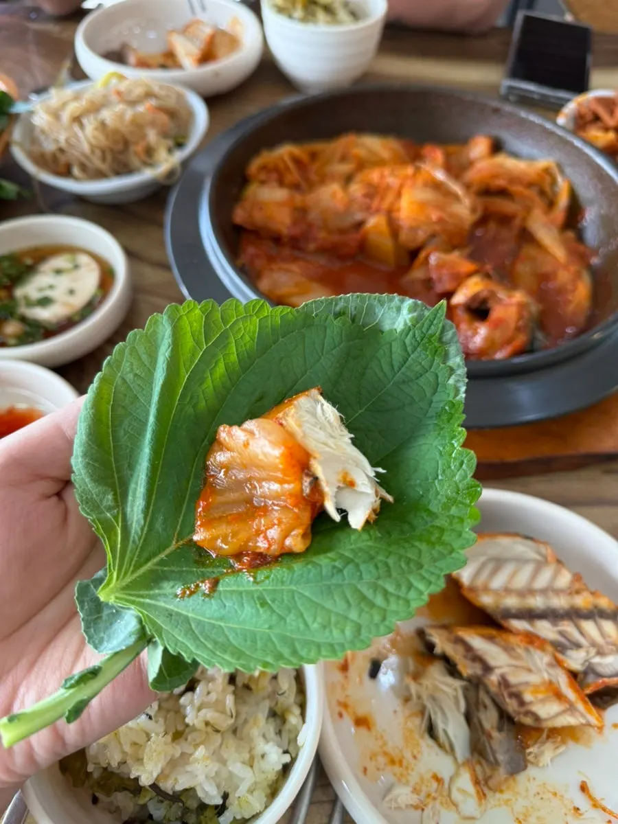 A wrap bite of aged kimchi and mackerel
