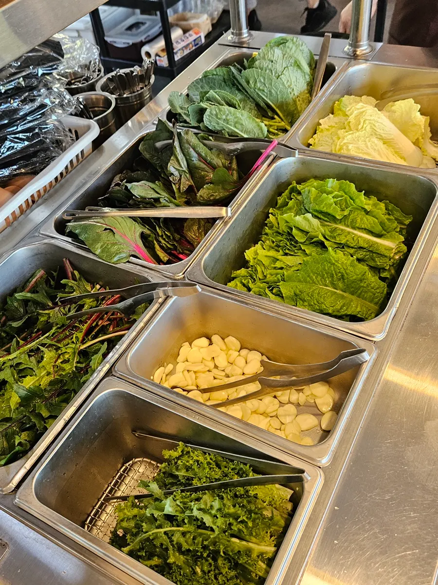 A plate of wrap vegetables and side dishes brought to the table