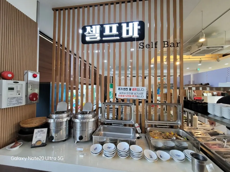 Neatly organized self-service bar at Jungmun Godeungeo Ssam-bap