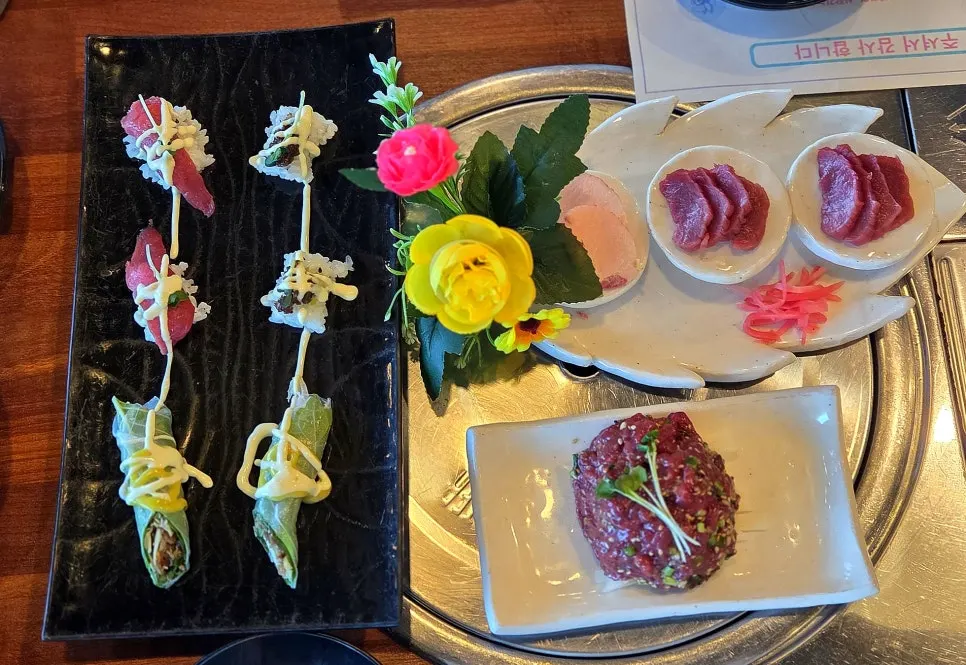 Course spread with three kinds of sushi, horse yukhoe, and horse sashimi