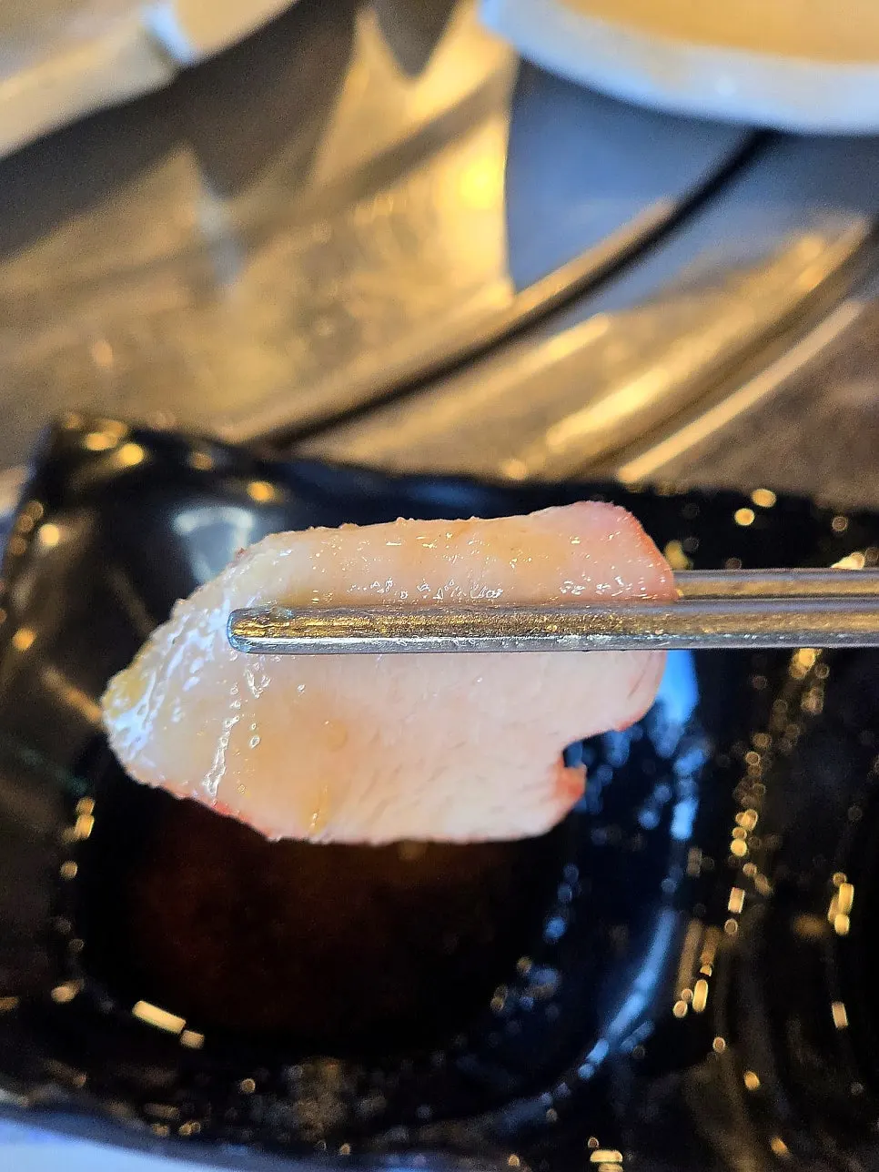 Picking up a piece of horse sashimi