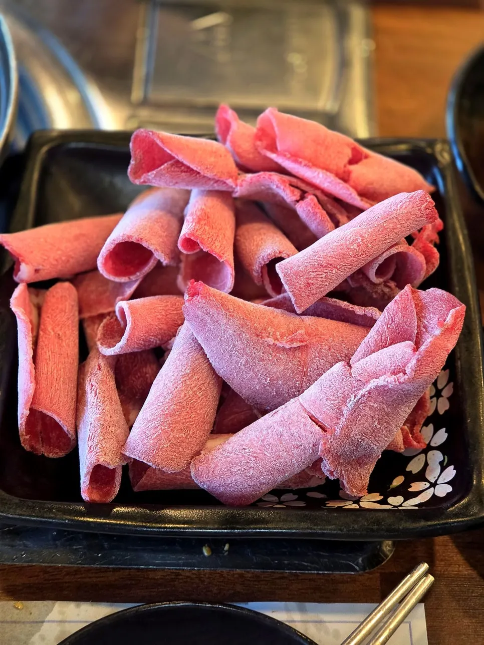 Cooking meat in the rich shabu-shabu broth