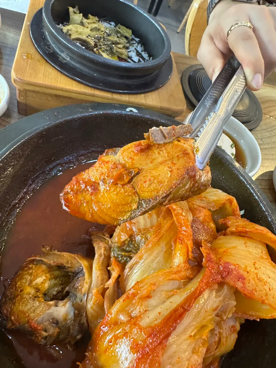 A hefty piece of mackerel hidden under the old kimchi