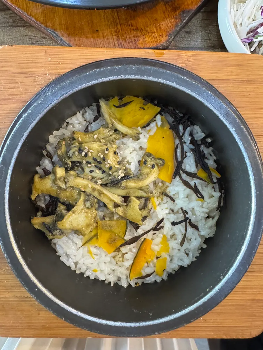 Abalone hot stone rice topped with abalone, sweet pumpkin, and tot