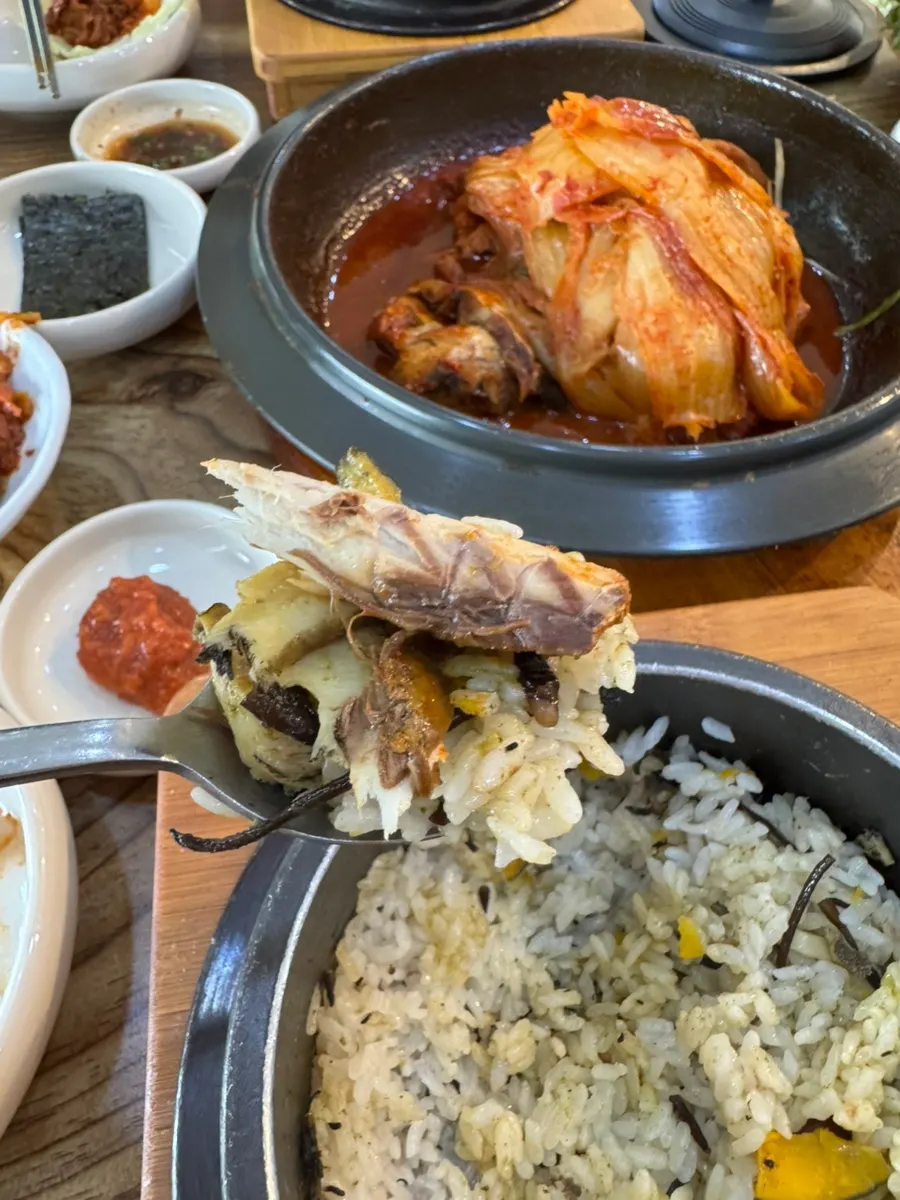 A hefty piece of mackerel flesh placed on top of the hot stone rice