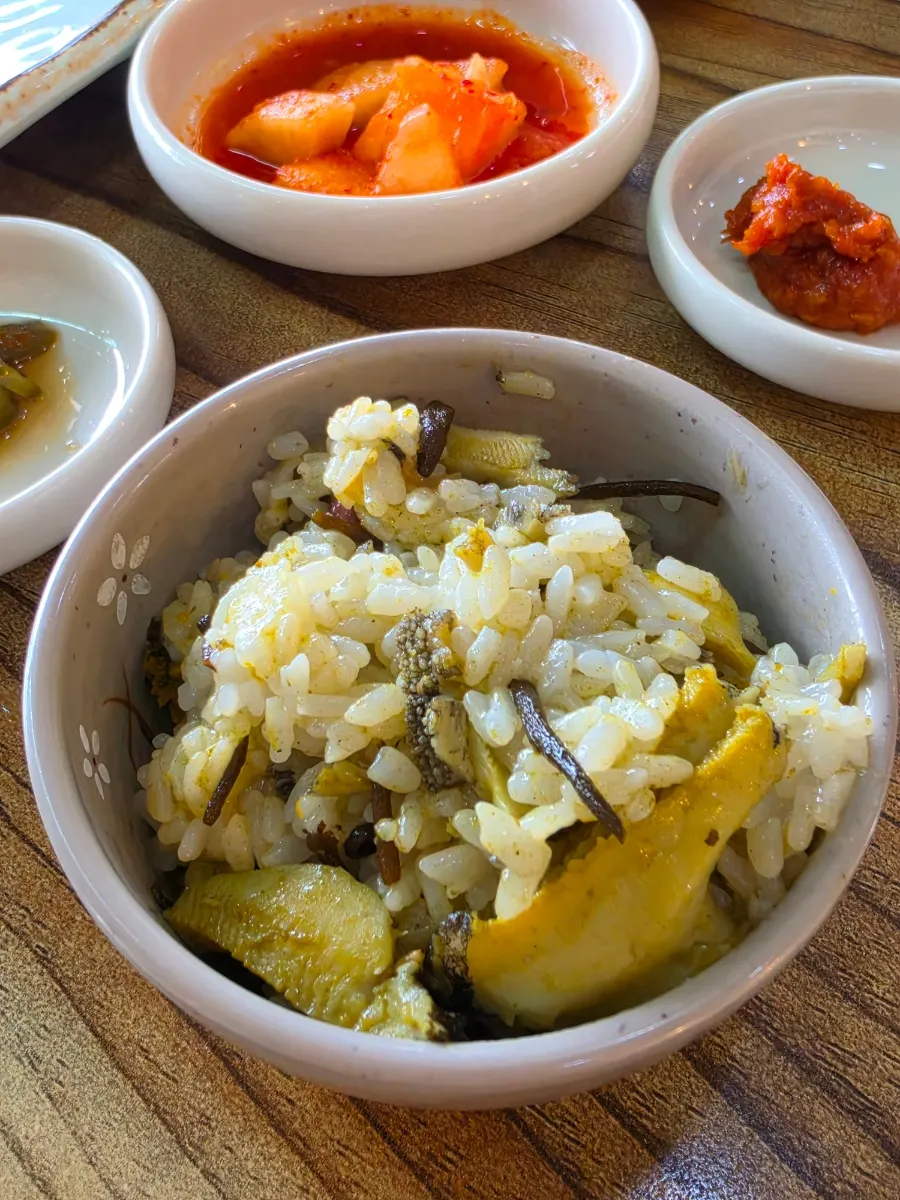 Close-up of hot stone rice topped with abalone
