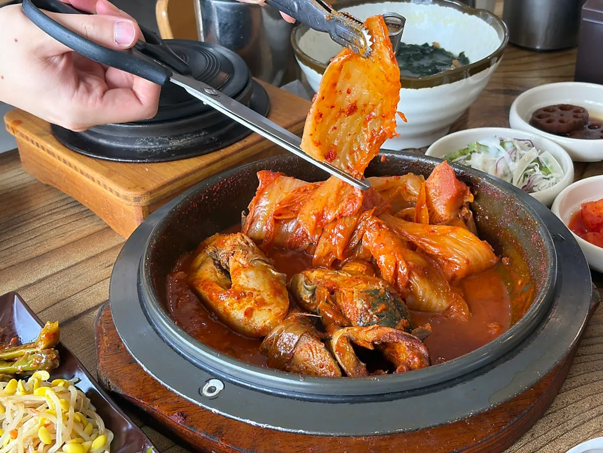 Plump braised mackerel underneath the aged kimchi