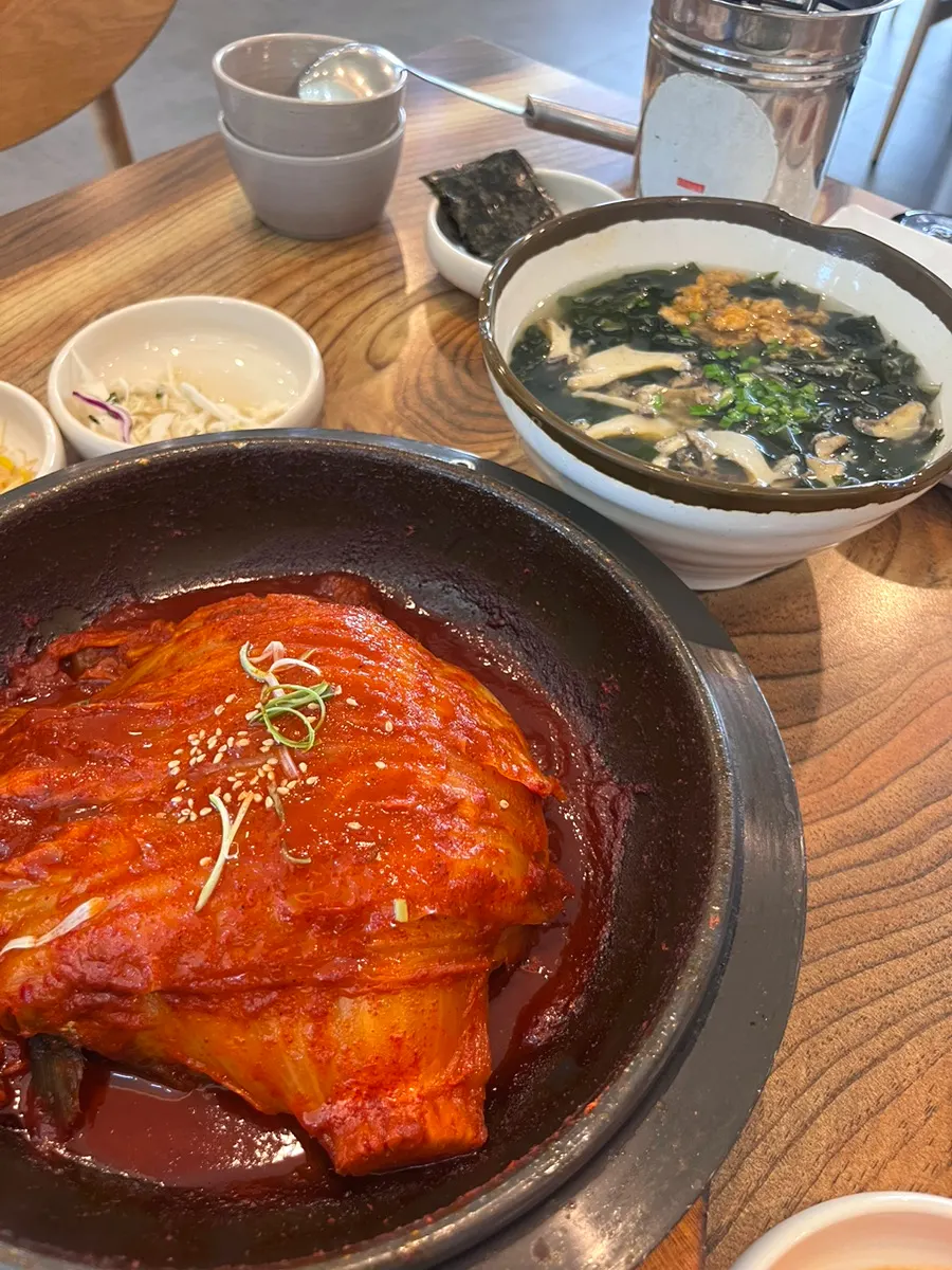 Table set with old kimchi braised mackerel and abalone-sea urchin seaweed soup