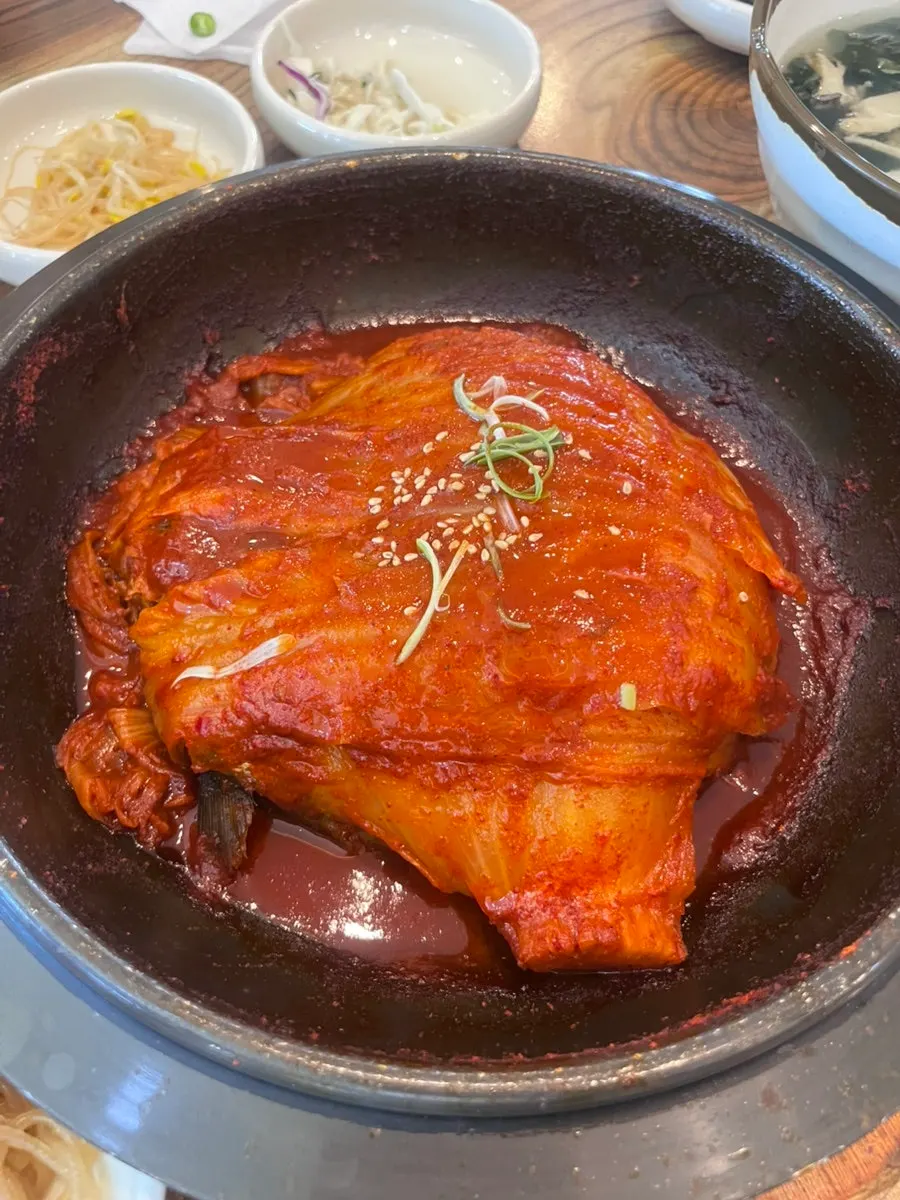 Pot of old kimchi braise covering the mackerel