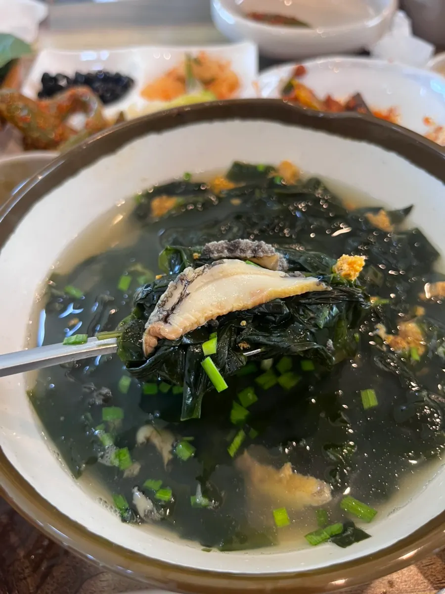 Spoonful of the rich abalone-sea urchin seaweed soup