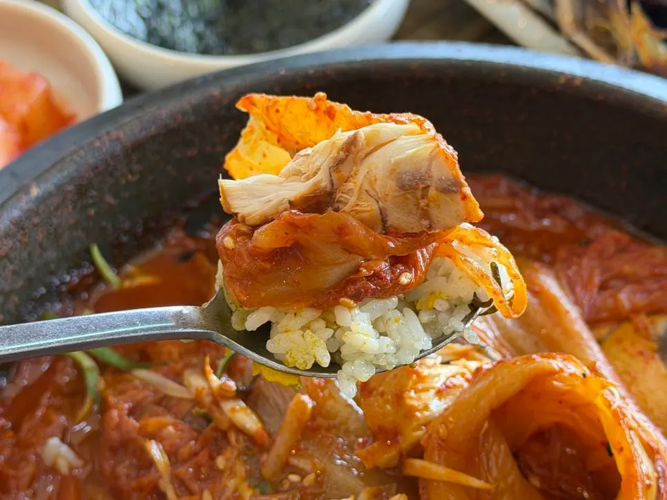 A ssam of old kimchi topped with mackerel flesh