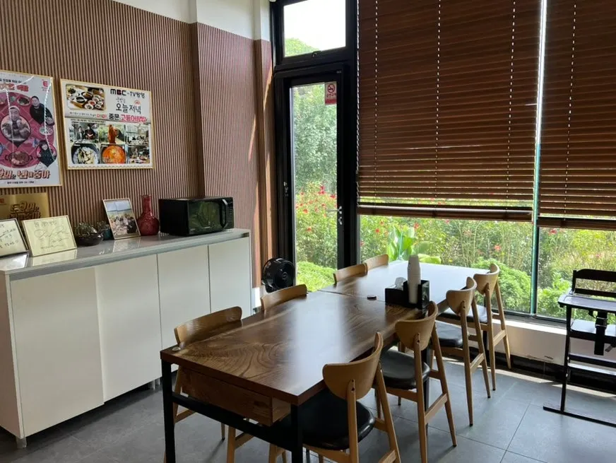 Spacious dining hall with many tables at Jungmun Godeungeo Ssam-bap