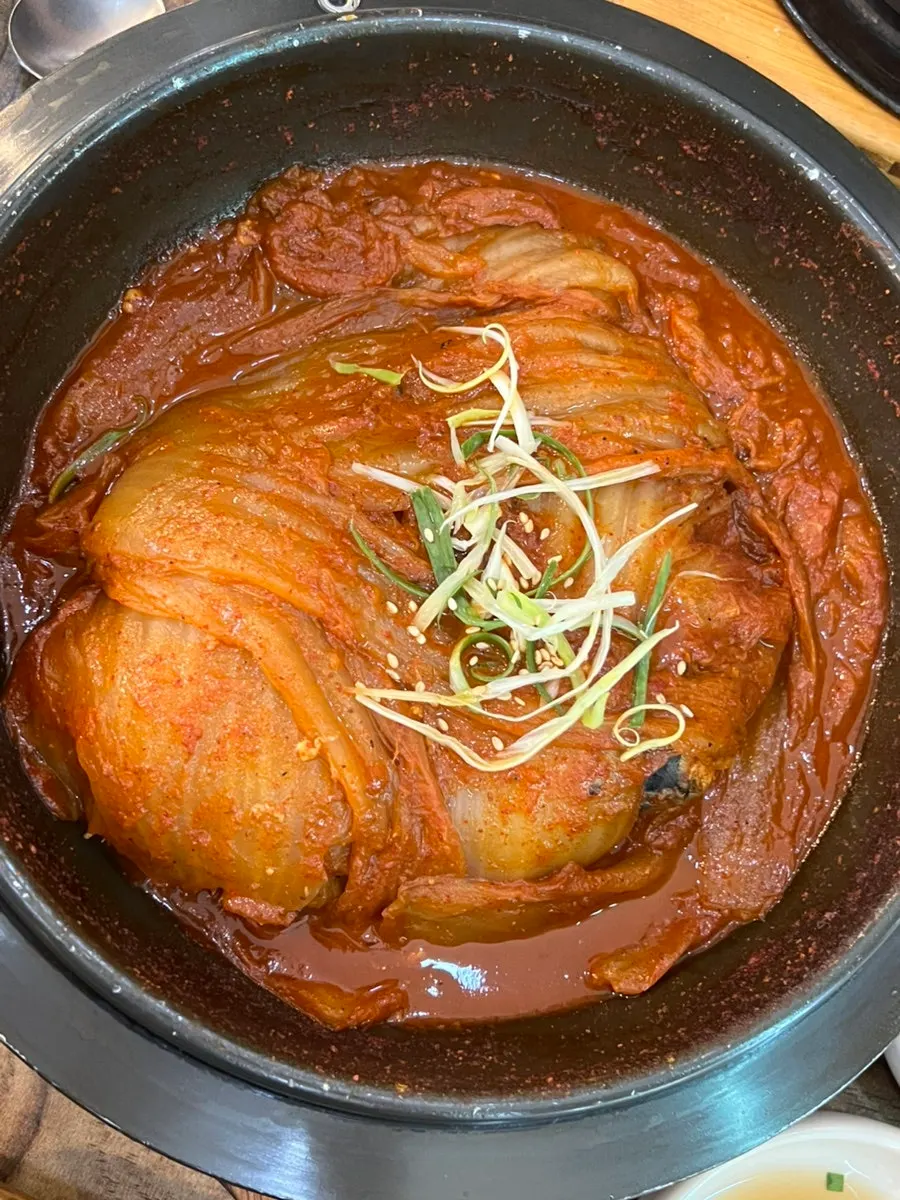 Pot of mackerel ssam-bap topped with whole old kimchi