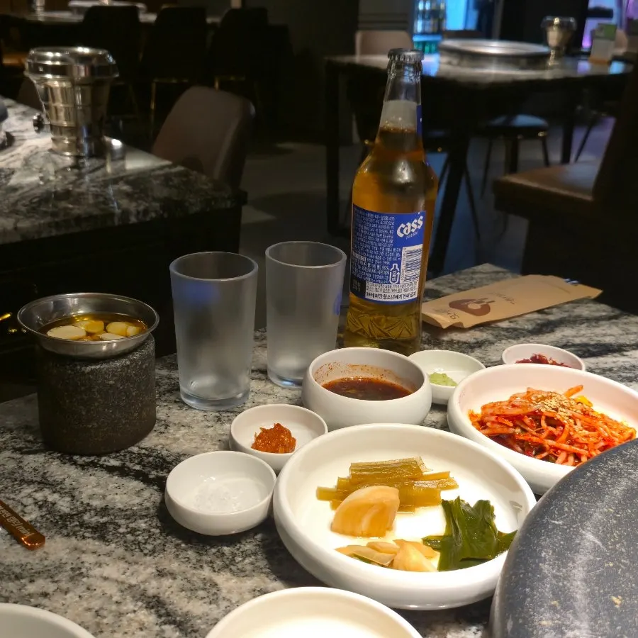 Side dish spread including house-made scallion sauce and fermented anchovy