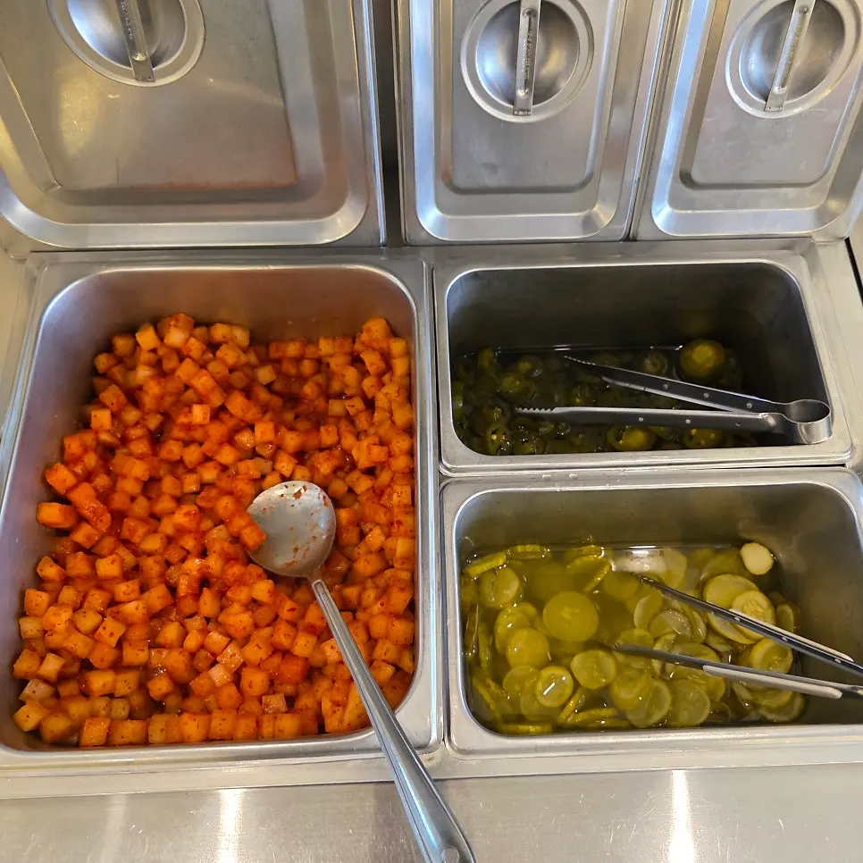 Self-serve bar with diced radish kimchi and pickles