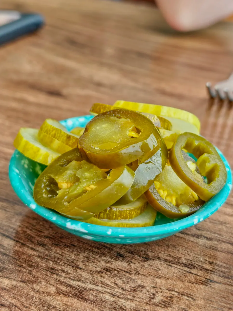 Plate of kkakdugi, jalapeños, and pickles