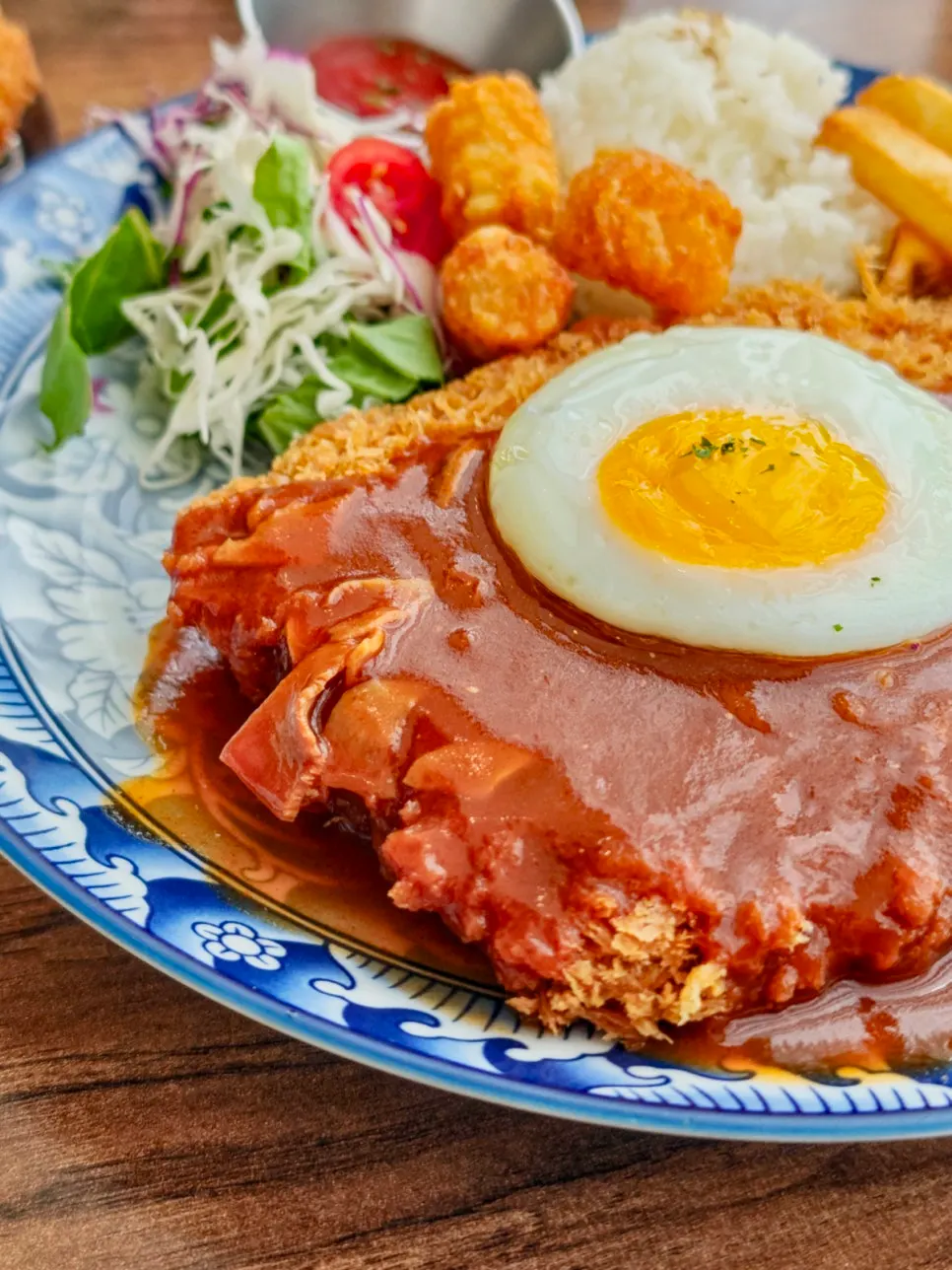 Pork cutlet set with fried egg, fries, rice, and salad
