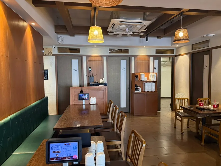 Wood-toned interior of the Junghwa Gaekjansu dining hall