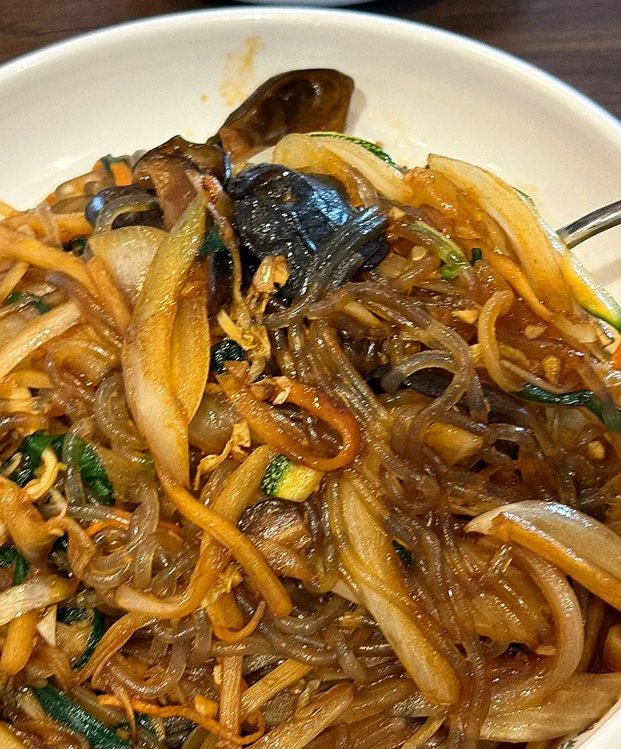 Close-up of glass noodles and pork in japchaebap