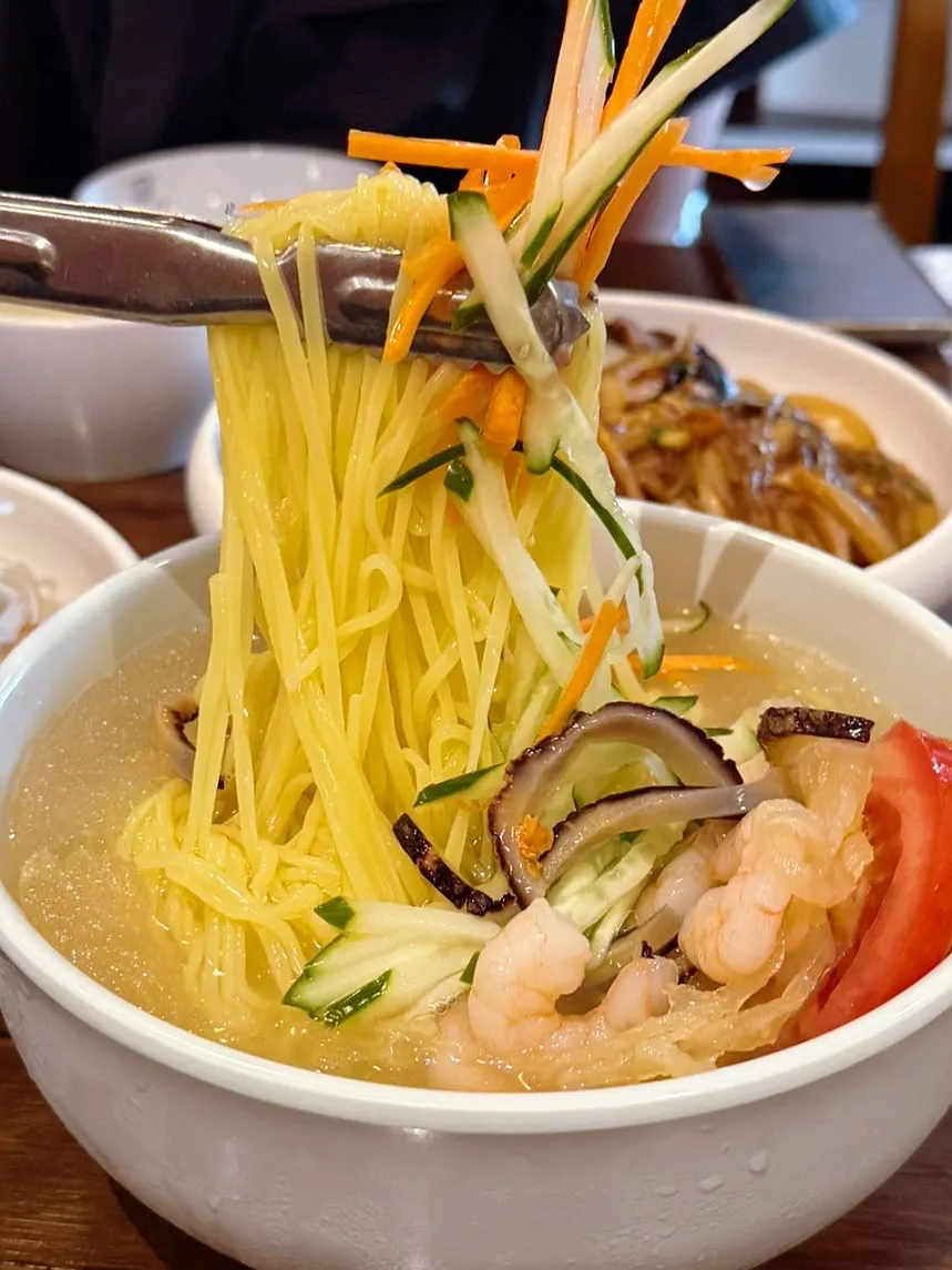 Jungwa naengmyeon topped with shrimp and jellyfish