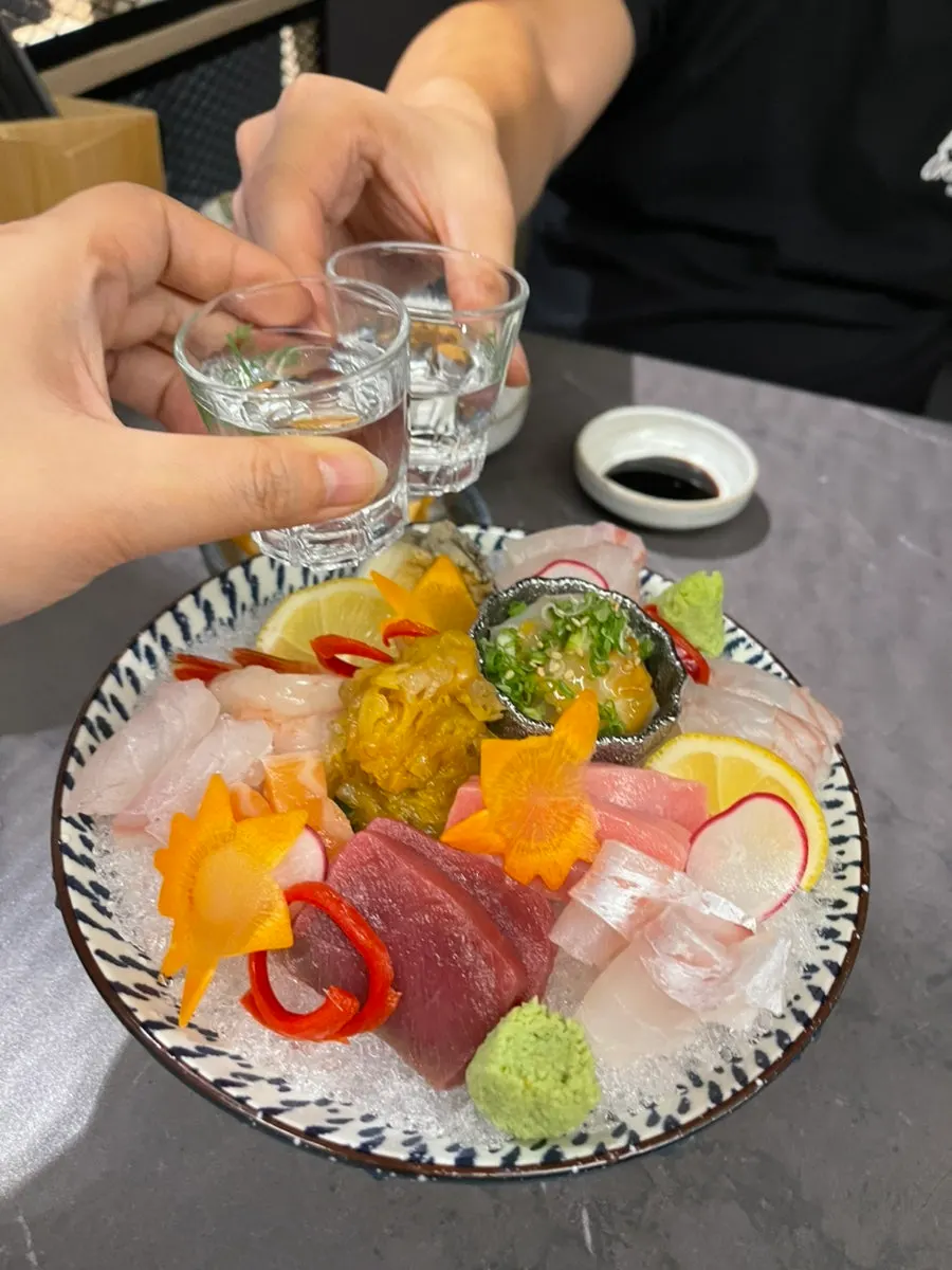 A glass of soju paired with the sashimi